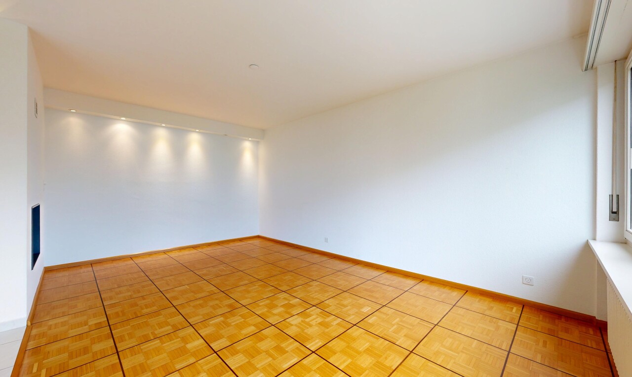 spare room featuring parquet floors and baseboards