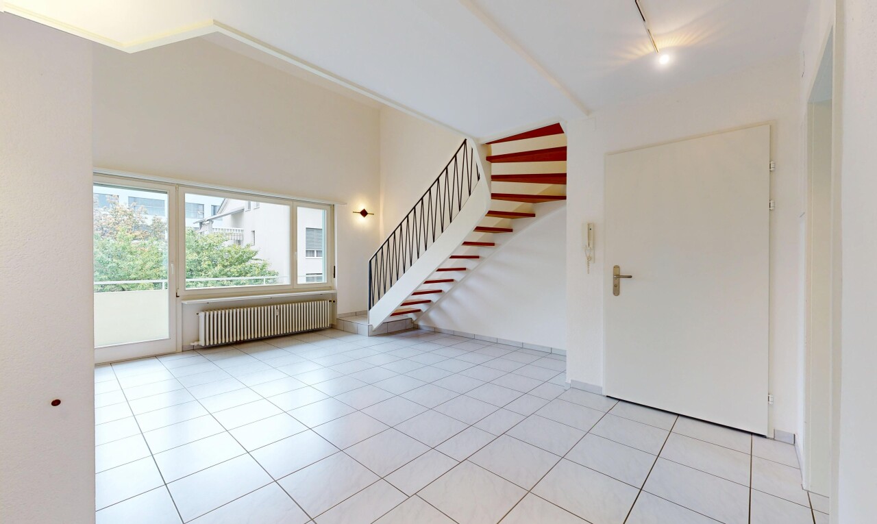 empty room featuring radiator and light tile patterned floors
