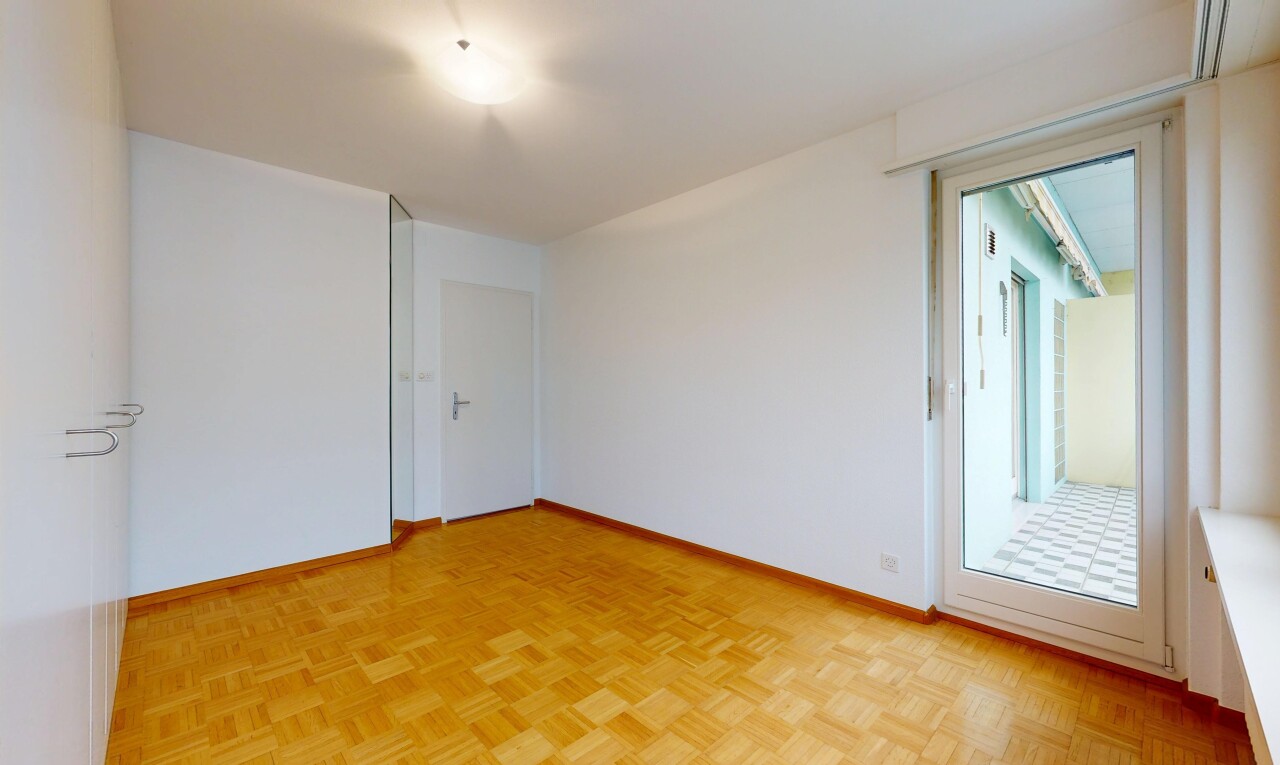 spare room featuring parquet floors and baseboards