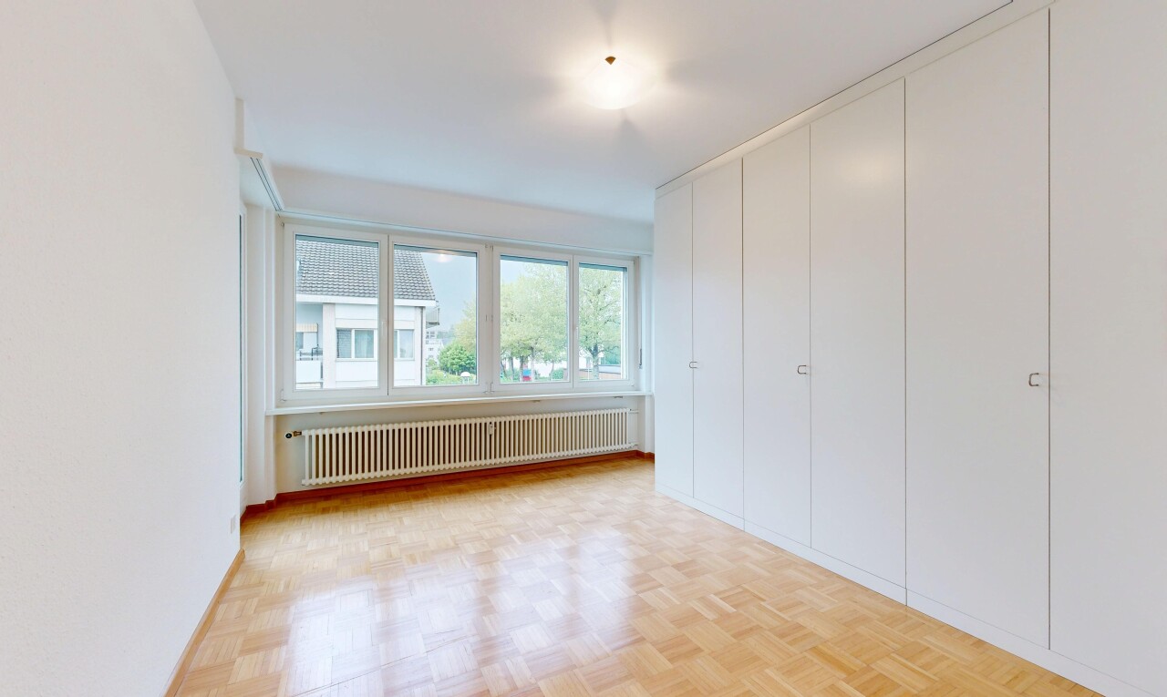 empty room featuring radiator and parquet floors