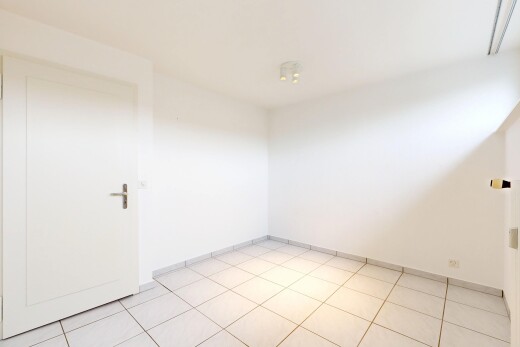 spare room featuring baseboards and light tile patterned flooring