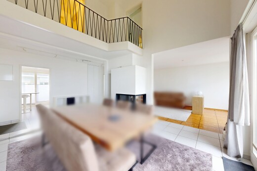 dining room with light tile patterned flooring and a high ceiling