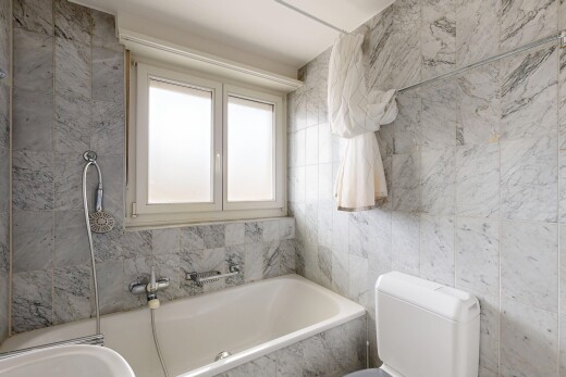 bathroom featuring tile walls, a bath, and a shower