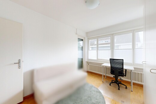 office with radiator heating unit and light wood finished floors
