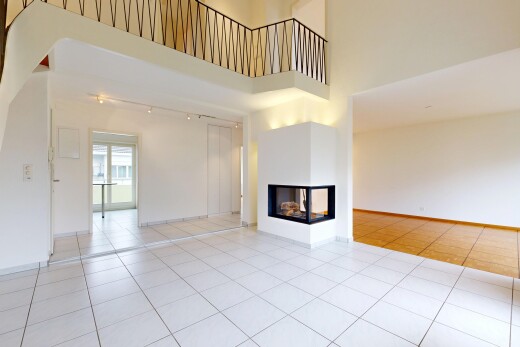salon avec plafond haut, high ceiling, light floor, cheminée, et inside property