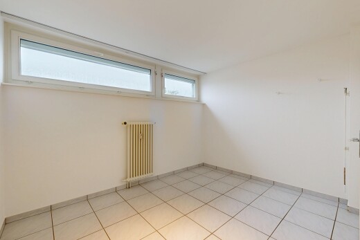 empty room featuring radiator heating unit and baseboards