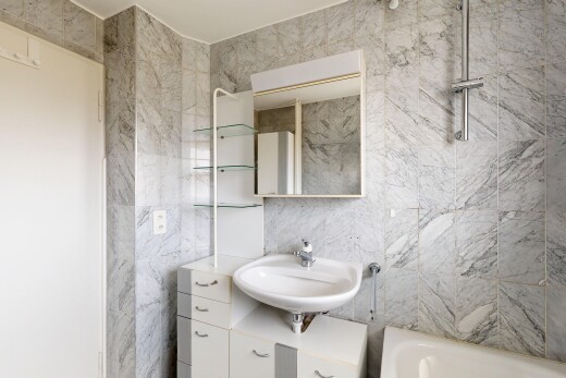 full bath with vanity, tile walls, and bathing tub / shower combination