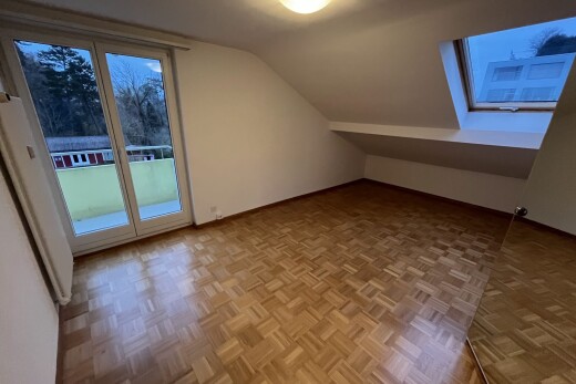 empty room featuring parquet floors and vaulted ceiling