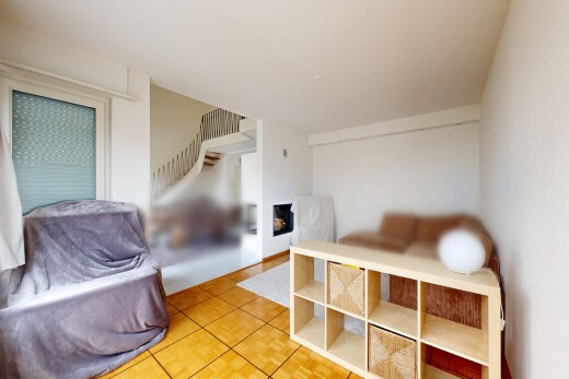 living area featuring light tile patterned floors and stairs