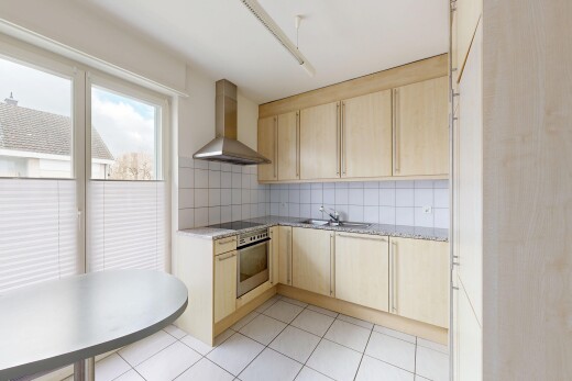 kitchen with light wood finish cabinetry, decorative backsplash, oven, and black electric stovetop