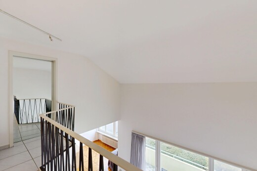 stairs featuring rail lighting and tile patterned floors