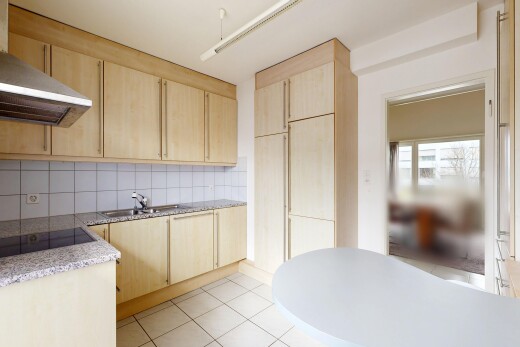 kitchen with light wood finish cabinets, decorative backsplash, black electric cooktop, light stone counters, and light tile patterned floors