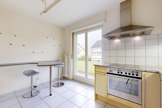 cuisine avec hotte, four, light floor, stone countertops, et plans de travail en pierre