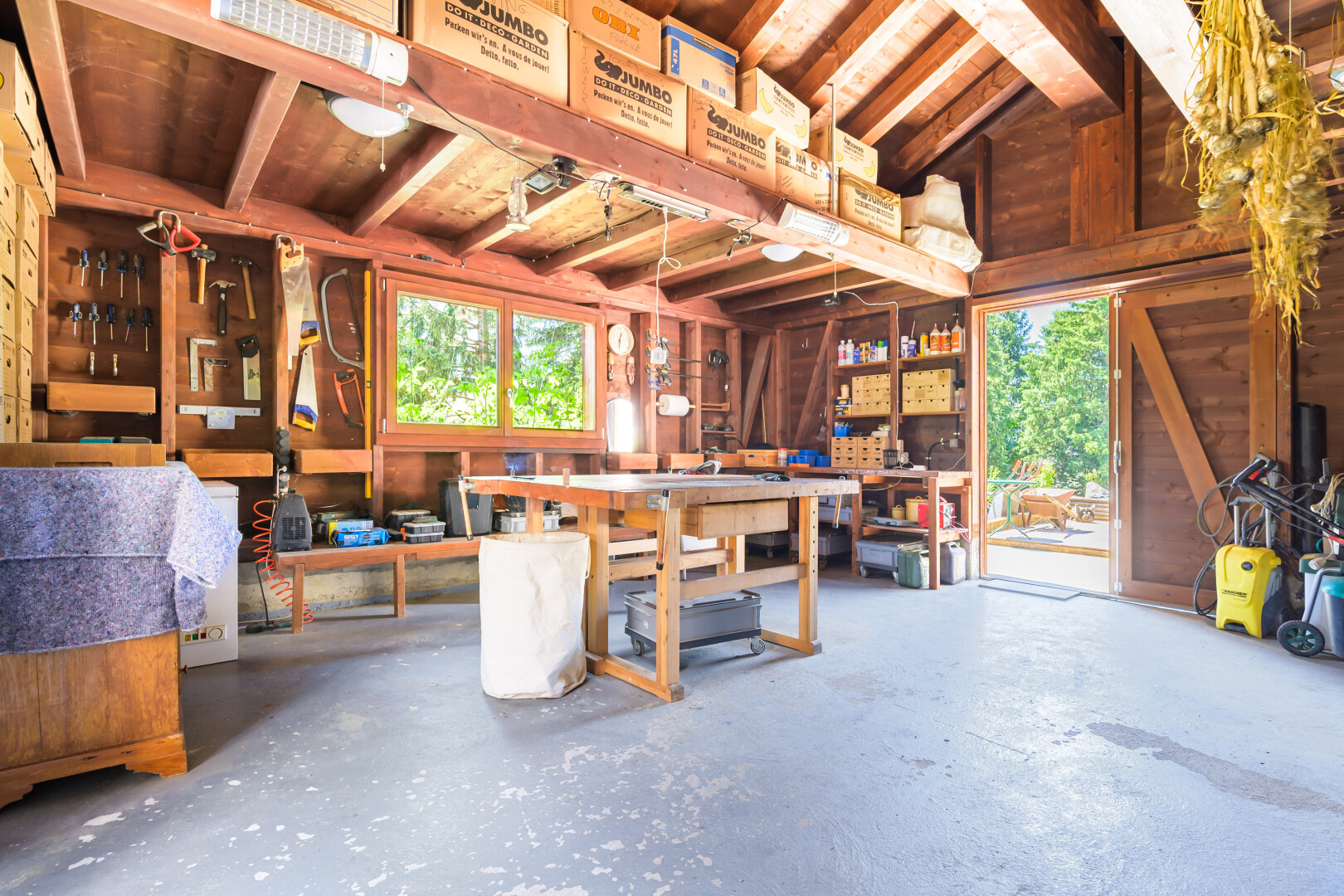 salle à manger avec atelier, sol en béton, concrete floor, inside property, et lumière naturelle