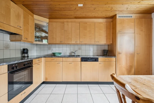 küche mit ofen, dark countertops, light floor, wood ceiling, und holzdecke