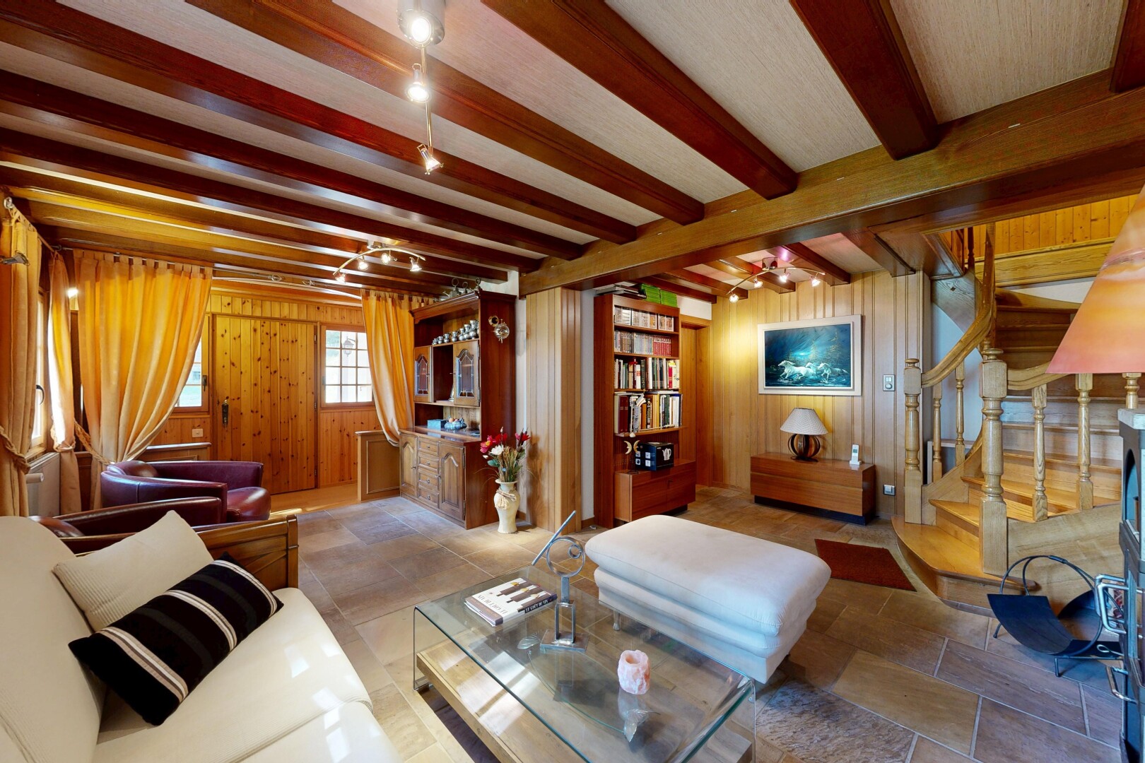 salon avec escaliers, inside property, wood wall, mur en bois, et beamed ceiling