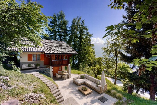 outdoor house with a patio, outdoor seating, and a tiled roof