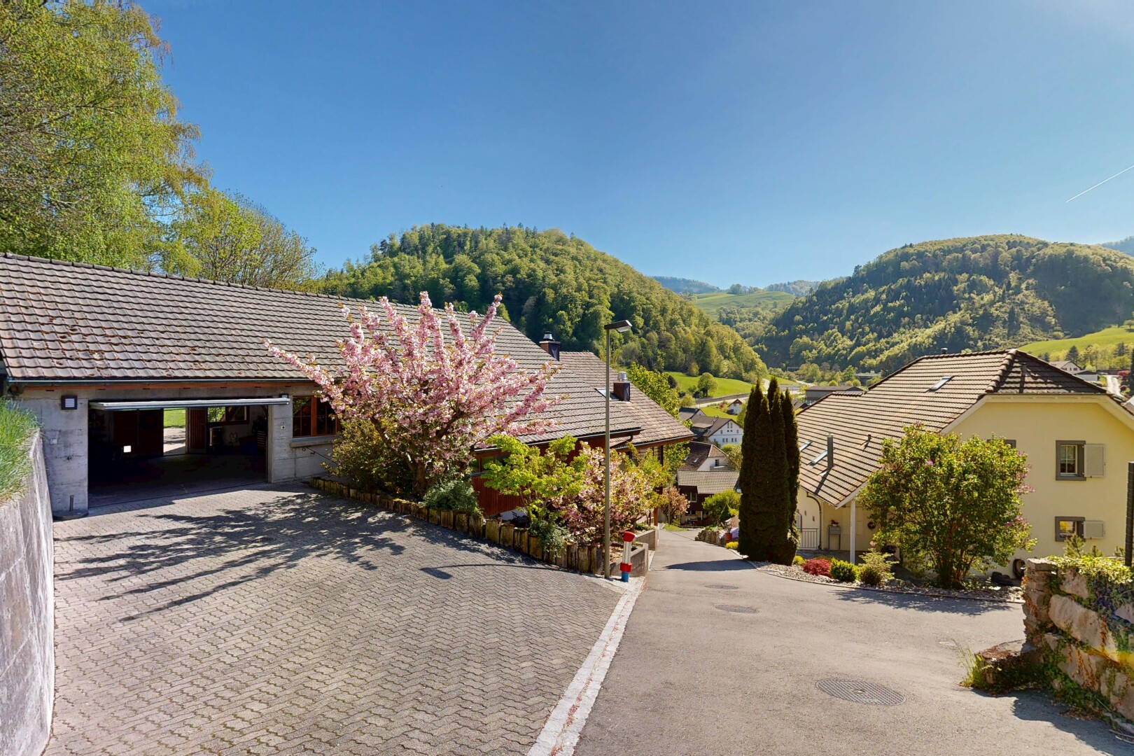 view of home with a mountain view, a garage, and decorative driveway