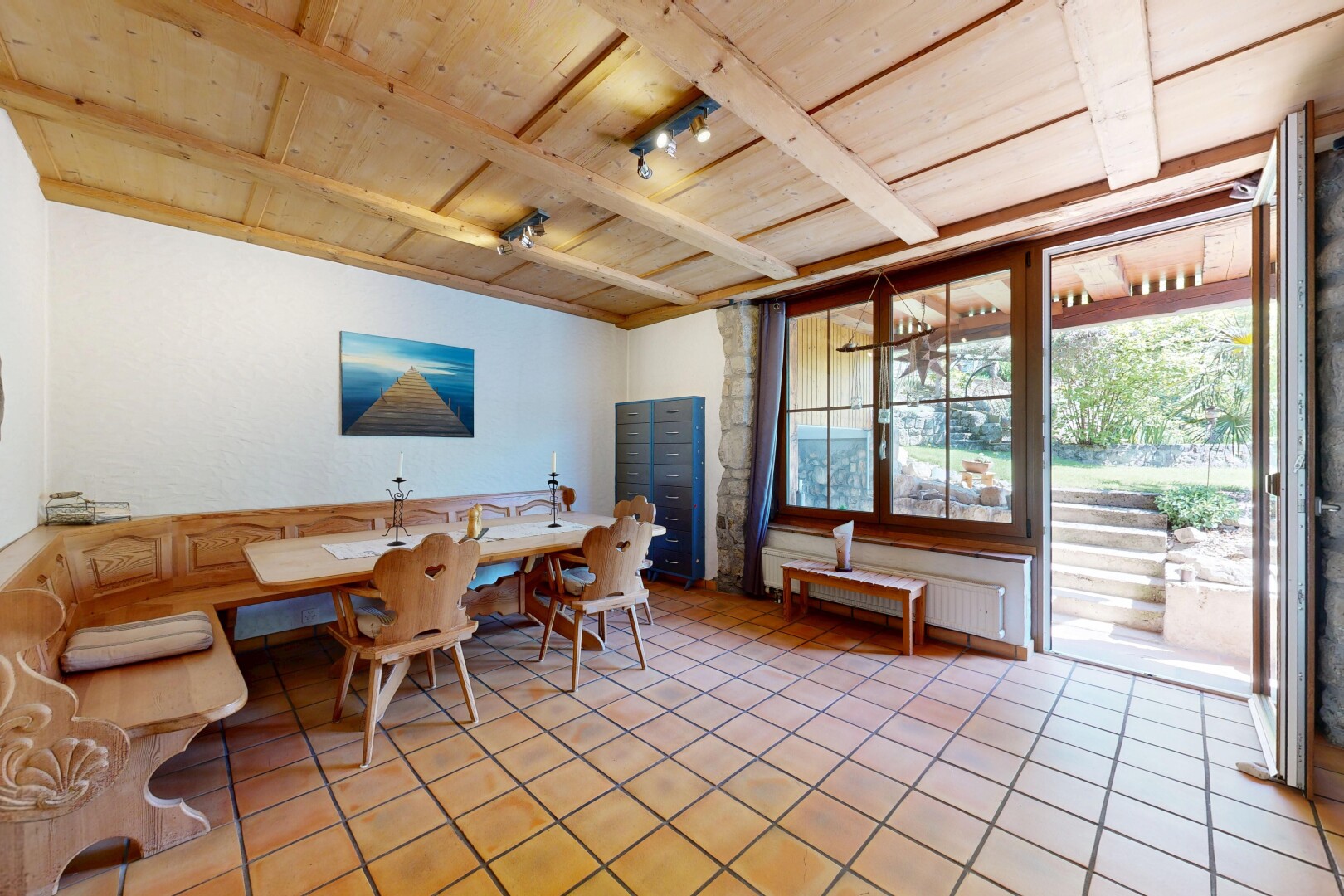 dining room featuring a wooden ceiling with exposed beams, radiator, and light tile patterned flooring