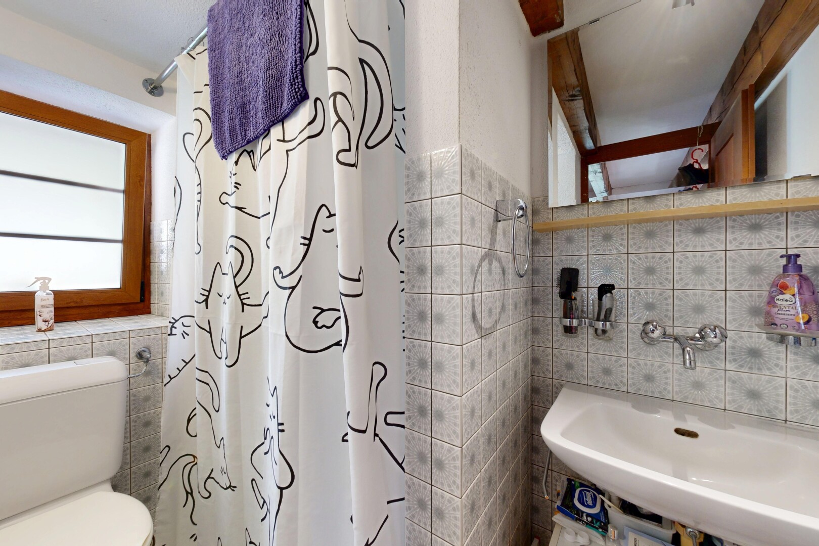 full bathroom featuring tile walls, plenty of natural light, and a shower with curtain