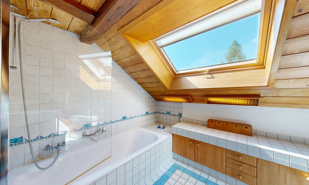 bathroom featuring a skylight and wood ceiling