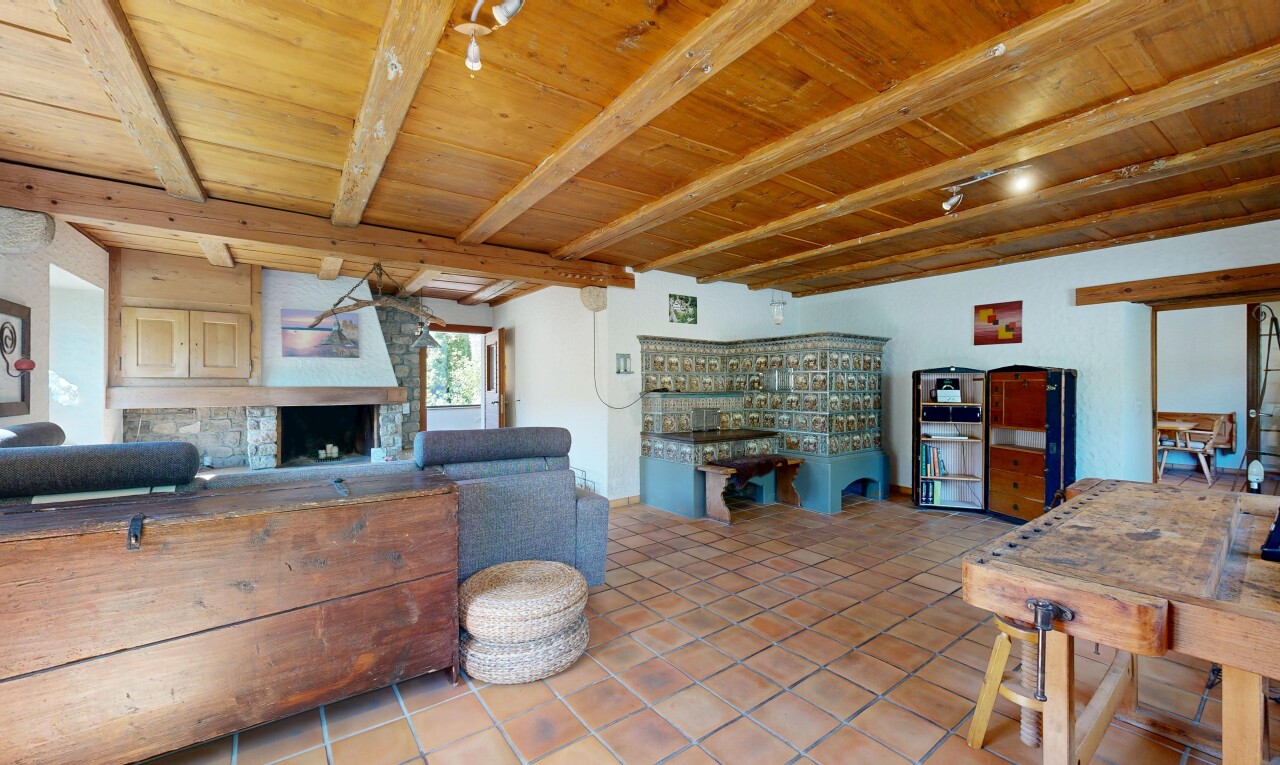 living area featuring a wooden ceiling with exposed beams, a large fireplace, and light tile patterned floors