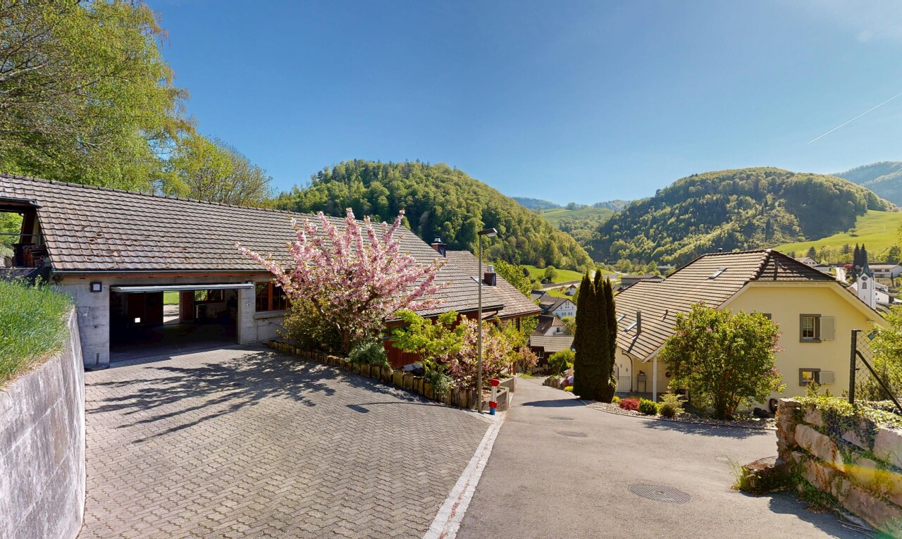 view of home with a mountain view, a garage, and decorative driveway