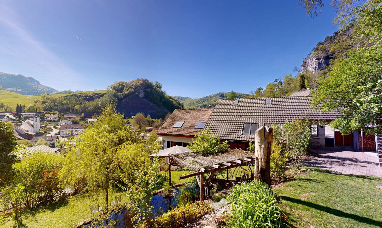 view of home featuring a mountain view and a tile roof
