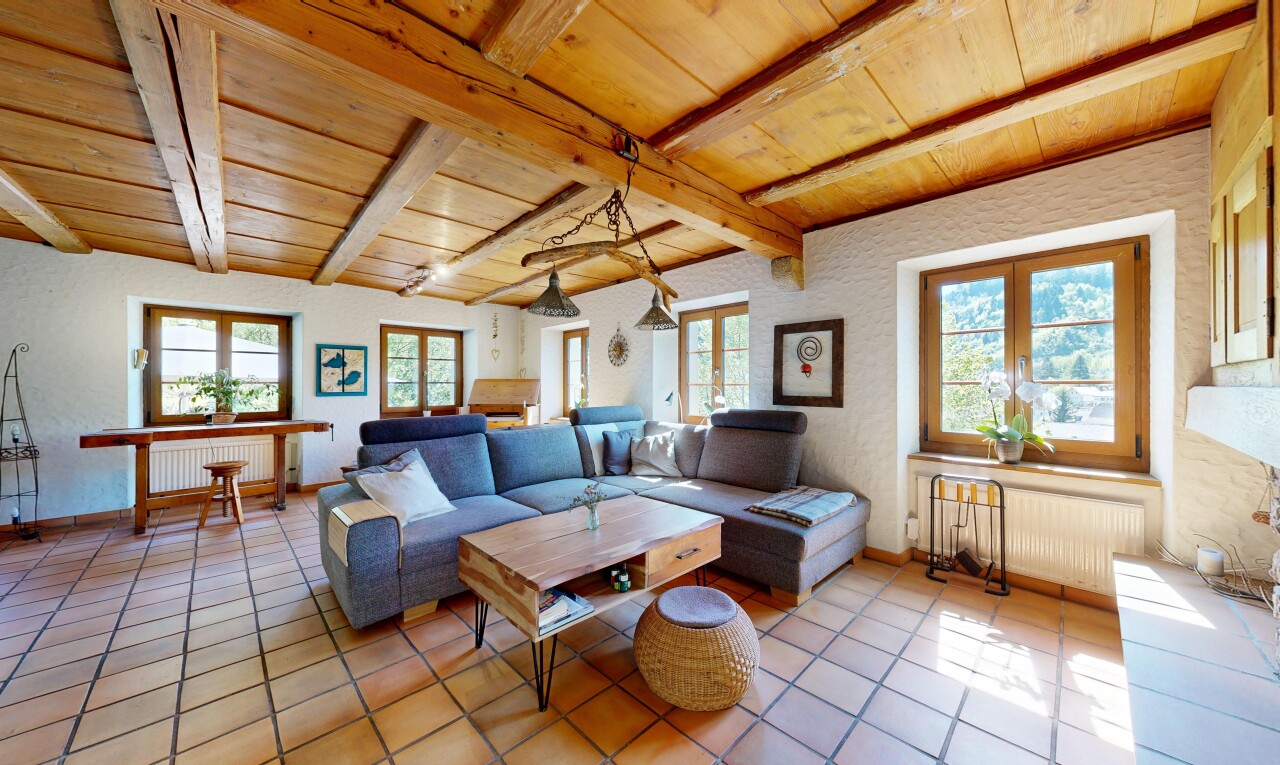 living room with a wood ceiling with exposed beams and radiator