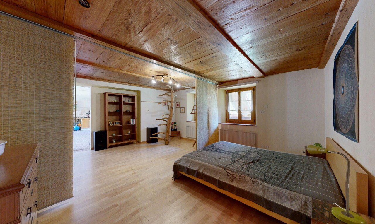 room featuring light wood-type flooring and a wooden ceiling with exposed beams