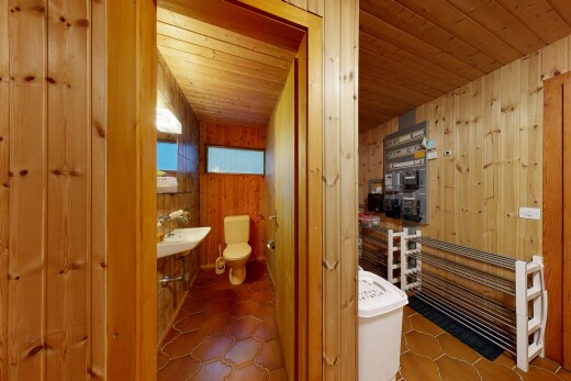 half bath with wooden walls and wooden ceiling