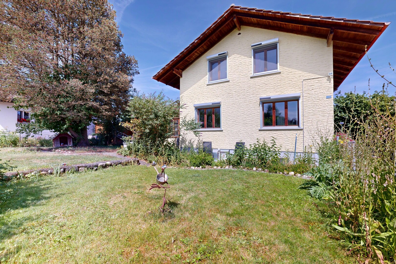 outdoor house featuring a lawn