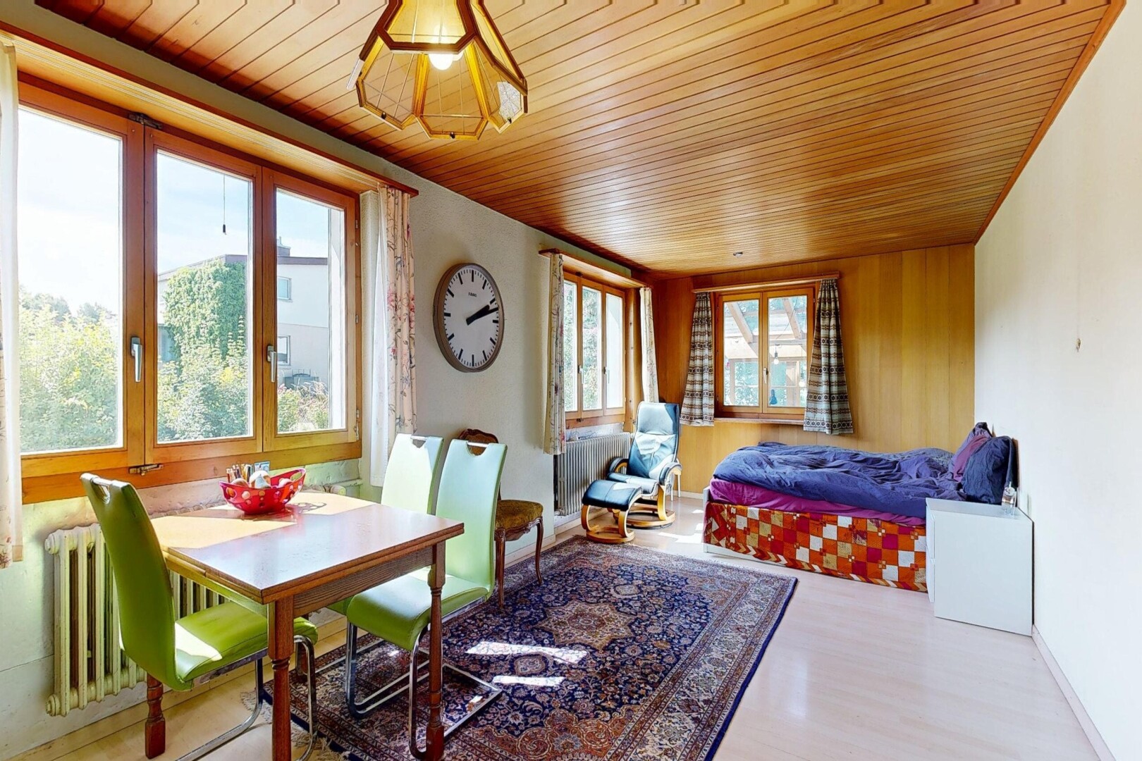 living / dining room with wooden ceiling, wood finished floors, and radiator