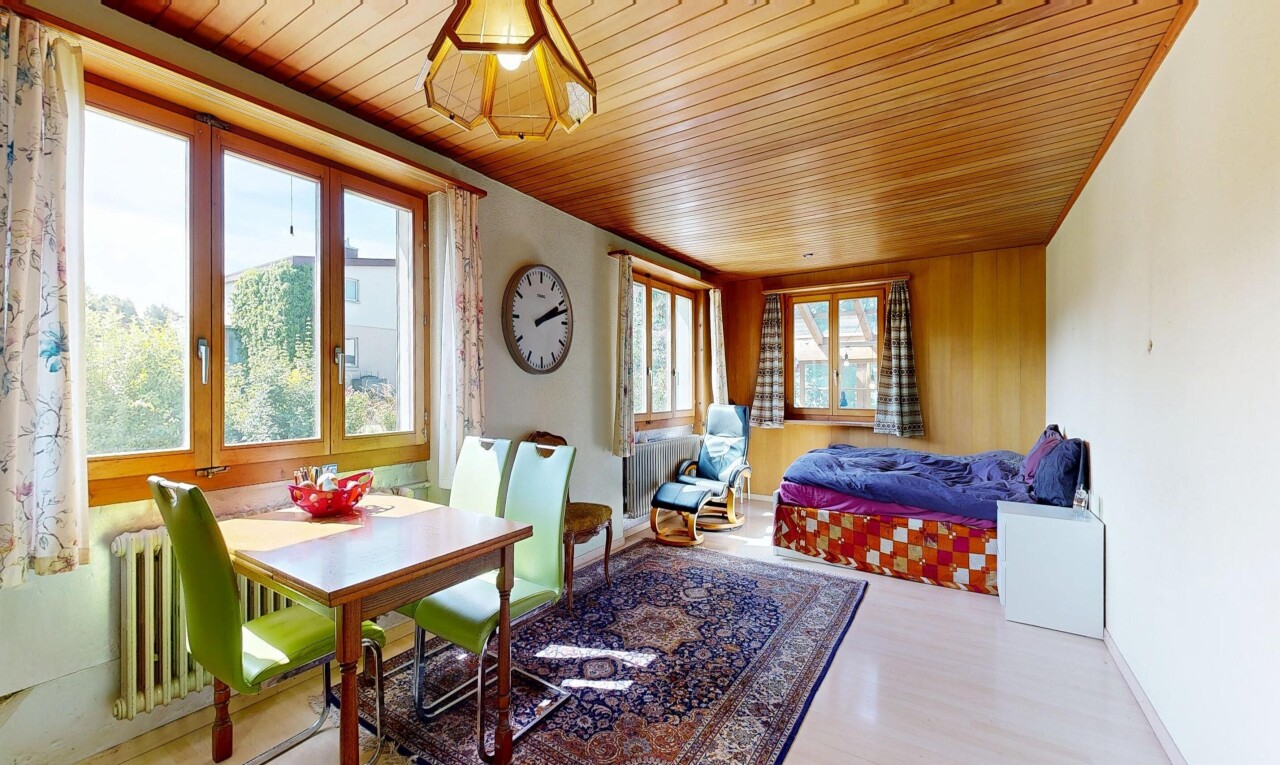 living / dining room with wooden ceiling, wood finished floors, and radiator