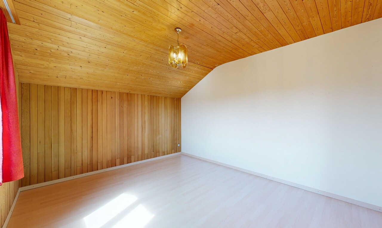unfurnished room with wood finished floors, wood walls, and a vaulted wooden ceiling