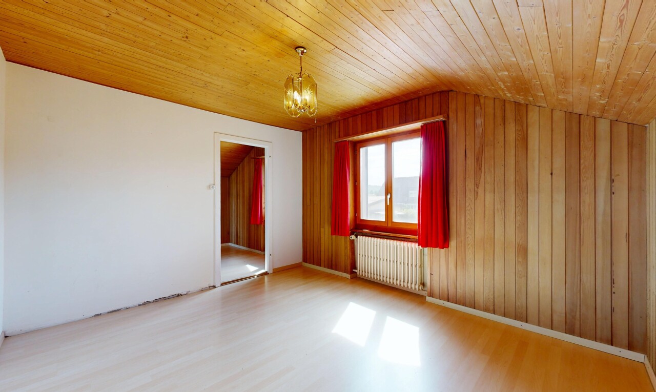 empty room featuring radiator heating unit, light wood-type flooring, wood ceiling, a chandelier, and wood walls
