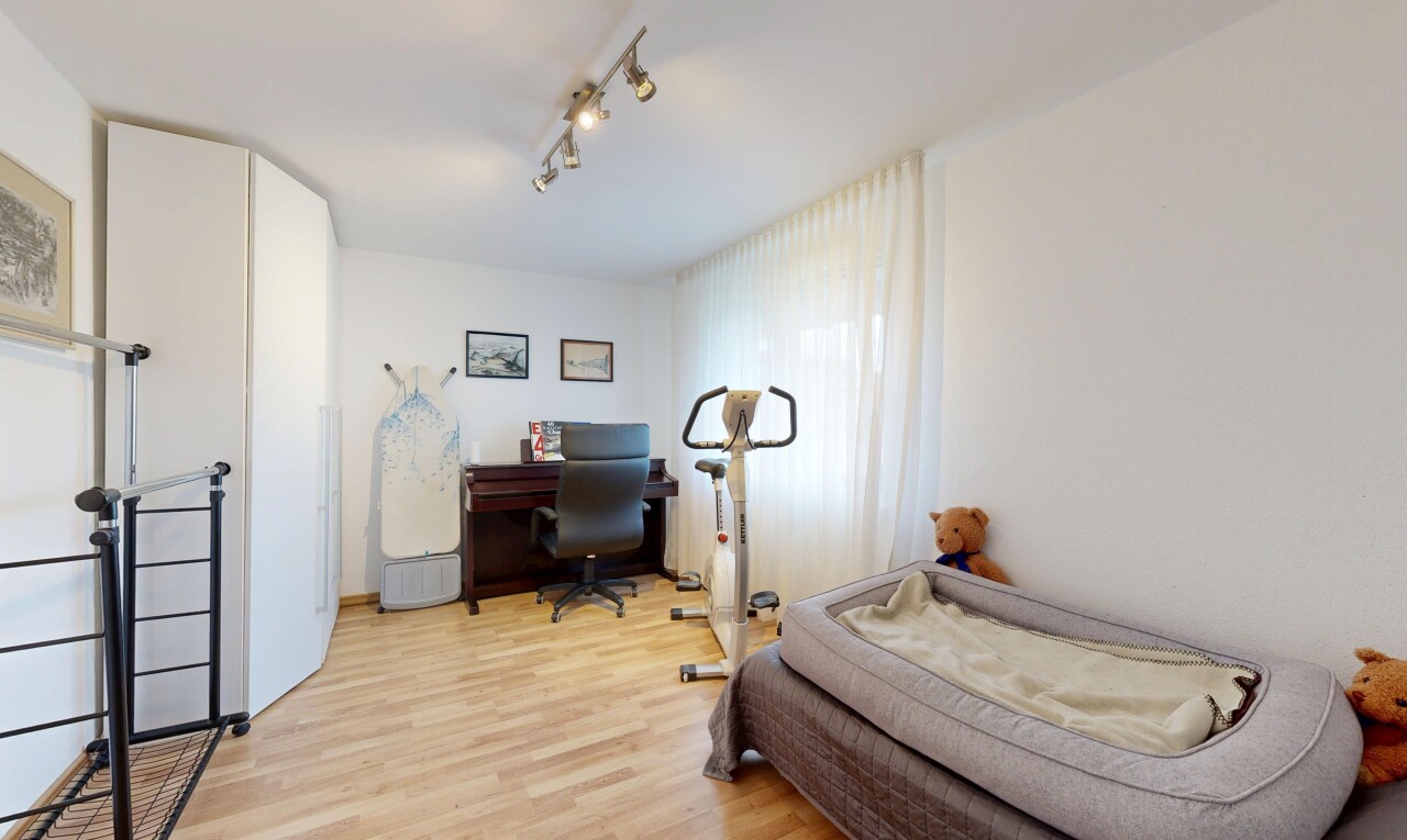 zimmer / schlafzimmer mit wood finish floor, holzfußboden, drywall, gipskartonwand, und bürobereich