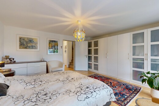 room featuring suspended lighting and light wood-style flooring