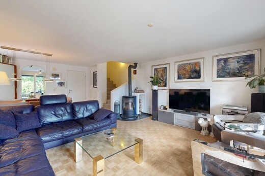 living room featuring parquet flooring and a wood stove