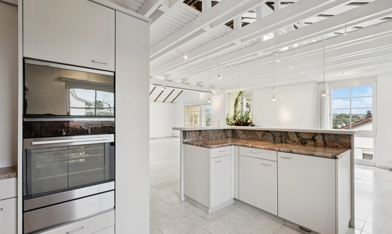 küche mit weiße schränke, white cabinets, dark countertops, two heights countertops, und doppel backofen