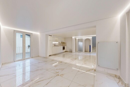 spare room with arched walkways and light marble finish floors