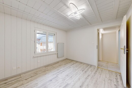 empty room with light wood-style floors and wooden ceiling