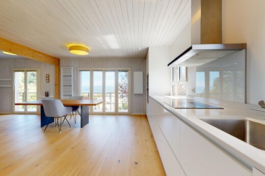 kitchen with light countertops, light wood-style floors, white cabinetry, black electric stovetop, and modern cabinets