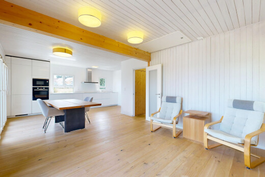 dining space featuring light wood-style floors and wooden walls