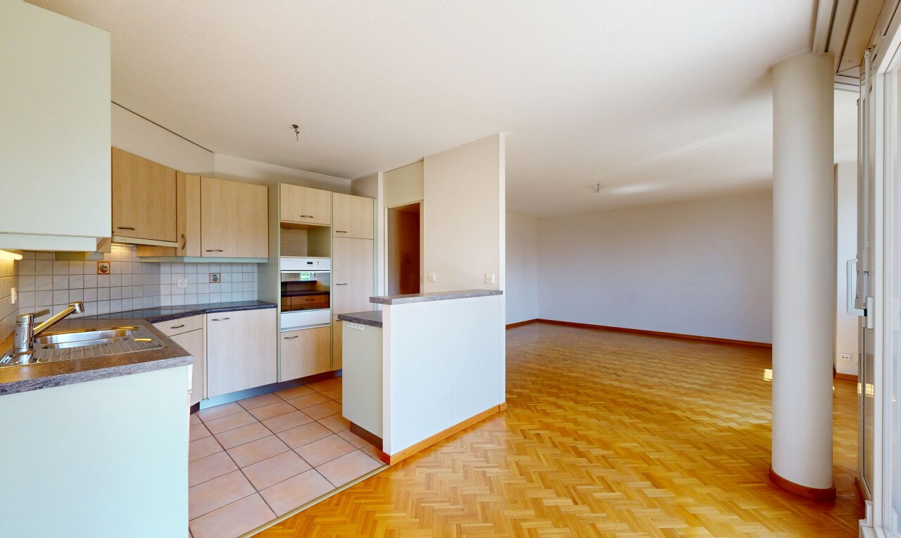 cuisine avec plans de travail, dark countertops, dosseret, backsplash, et armoires marron clair