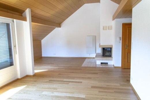spare room with a wooden ceiling with exposed beams, a multi sided fireplace, and light wood finished floors