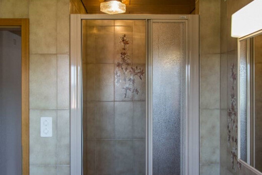 full bath featuring a shower stall