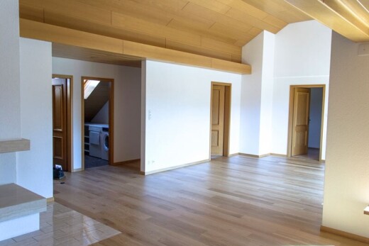 unfurnished room with light wood-style flooring, lofted ceiling, and washer / dryer