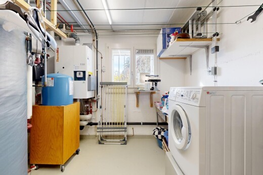 laundry area with washer / dryer, finished concrete floors, and water heater