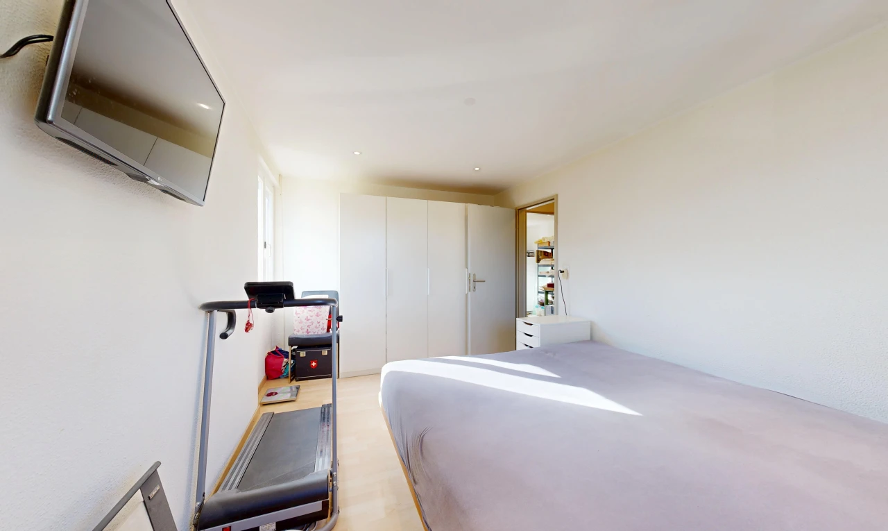 chambre avec télévision, cloison sèche, drywall, et placard